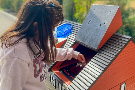 Girl dropping off pull tab donation to RMHC Dayton