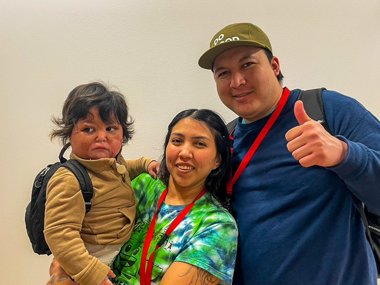 Mom and dad holding young boy