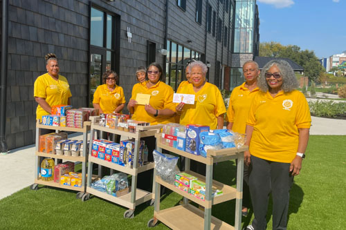 Group of women from the Golden Circle standing with their donation of wishlist items