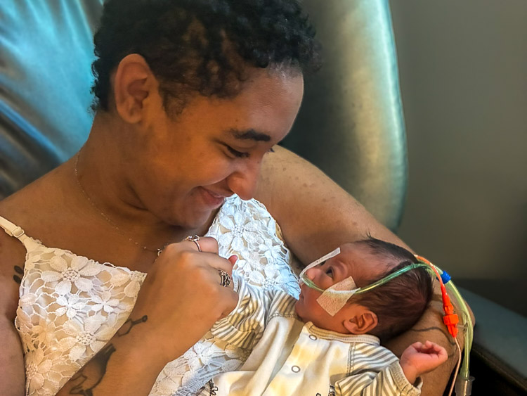 A mom holding her newborn son