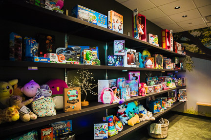 Lots of toys on shelves in toy closet