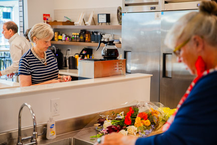 Two women in the volunteer kitchen preparing food
