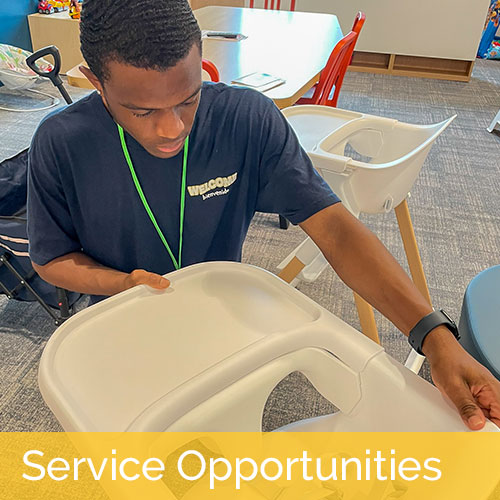 Young high school student volunteering to put together a high chair.