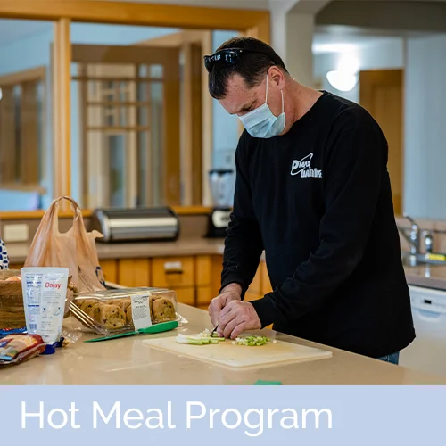 adult male carefully preparing a meal for guests at rmhc Dayton